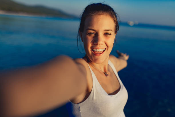 istock Young woman enjoying on beach at dusk 1146123352