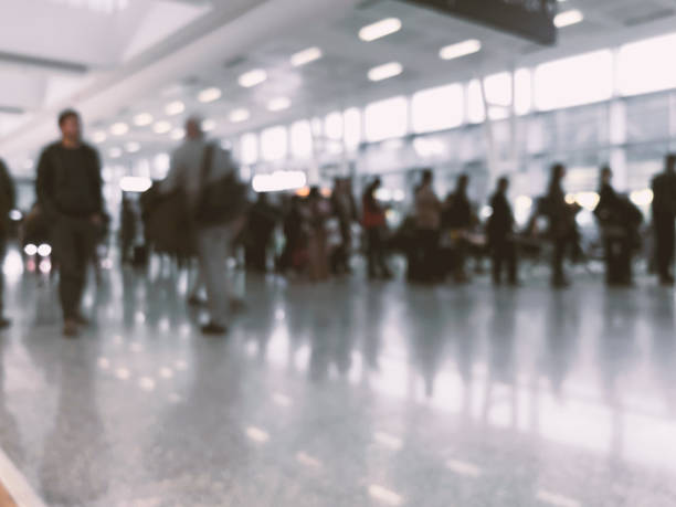 istock Defocused People waiting in a queue  in front of a gate at the airport. 1146123620