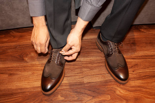 istock Man adjusting shoelaces before getting up to walk 1146123694