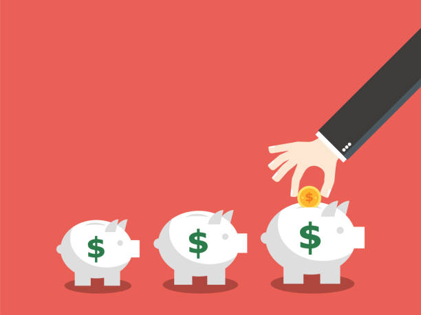 istock Business hand insert money into the piggy bank. 1146127508