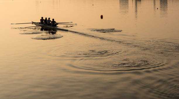 team of four rowers practice in racing canoe - remando imagens e fotografias de stock