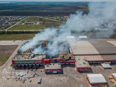 Aerial view of burning industrial distribution warehouse.