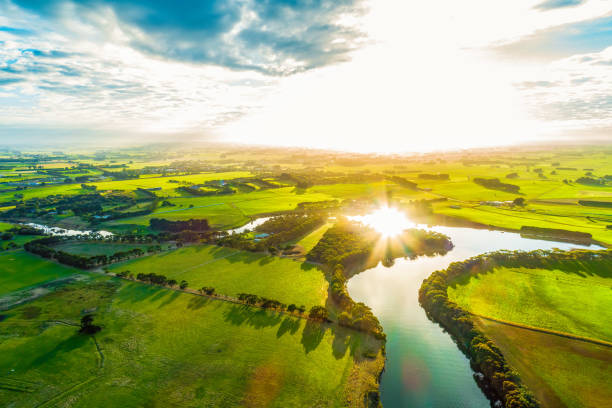 istock Bright sunset over scenic river in lush green countryside 1146135570