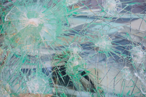 istock photo broken window looks like bullet hole 1146136603
