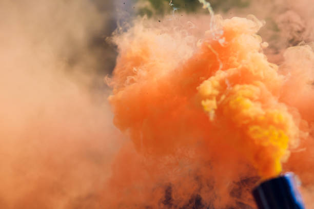 istock colorful orenge smoke bombs in action 1146137748