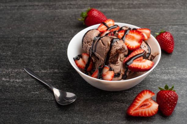 istock chocolate ice cream with strawberries on a dark background with a spoon, summer mood 1146137749