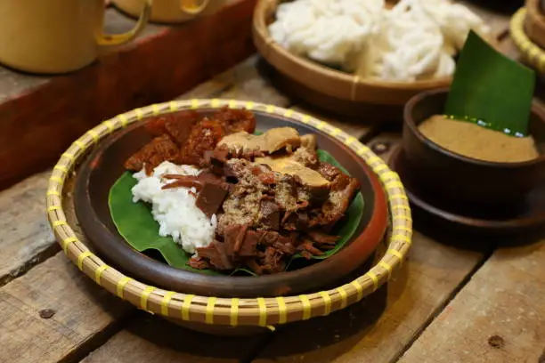 Photo of Nasi Gudeg, the Traditional Javanese Rice Dish with Jackfruit Stew, White Chicken Curry and Spicy Cattle Skin Stew