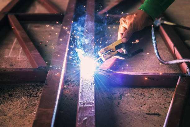 istock close up hand welding steel with spark 1146140223