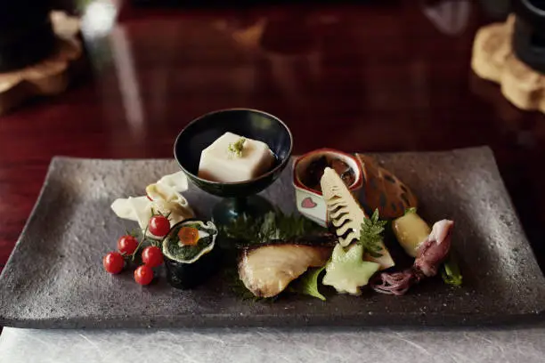 A selection of tofu, vegetables and seafood plated beautifully in Kyoto, Japan.  One part of a traditional seven course, Kaiseki meal.