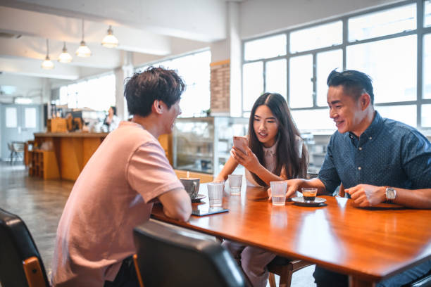 istock Mature man talking to friends at cafe table 1146143280