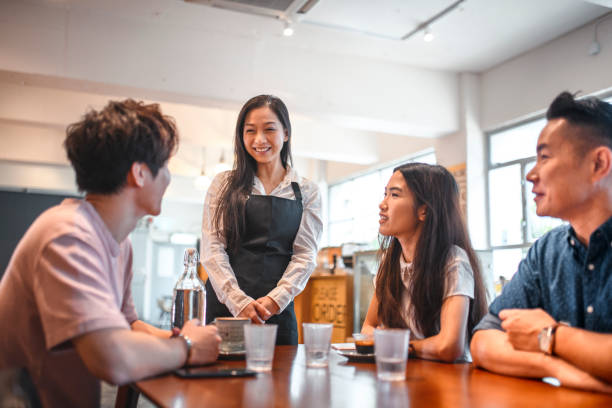 istock Female barista serving coffee to customers 1146143284