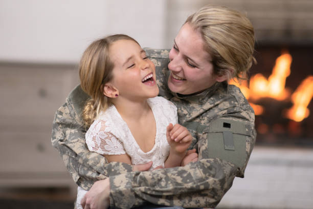 military mom hugging ihre tochter - canadian soldier stock-fotos und bilder