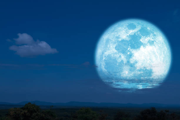 istock Full hay moon halo back silhouette mountain and hill 1146150782