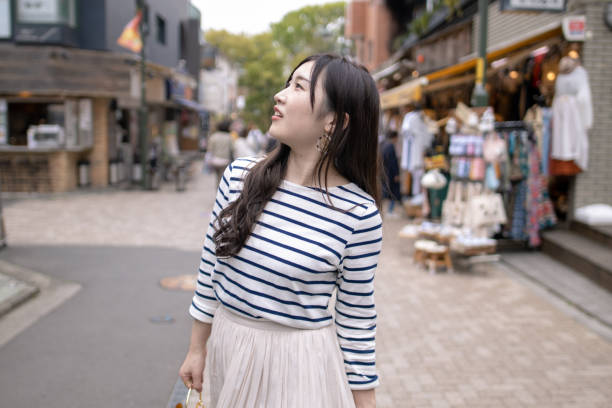 istock Young woman walking on shopping sreet 1146152043