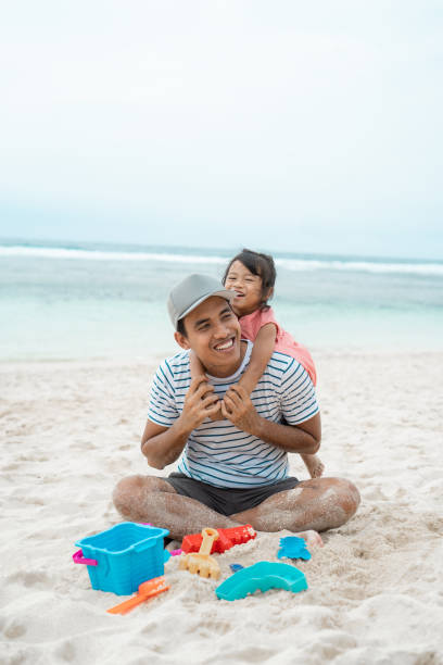 istock daughter embracing his father from behind when playing 1146153929