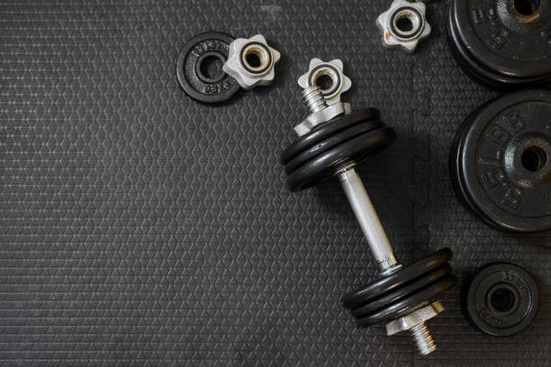 istock Top view of Iron dumbbells or weights on black floor with copy space for text. Flat lay composition. Health care concept. 1146156494