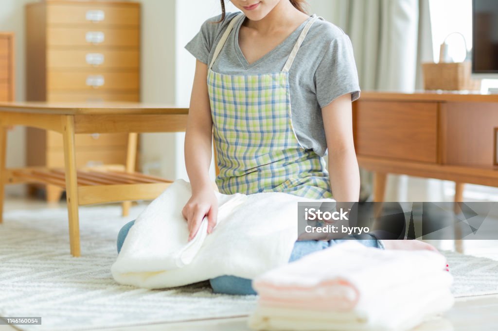 Housewife folding laundry Person Laundry Stock Photo