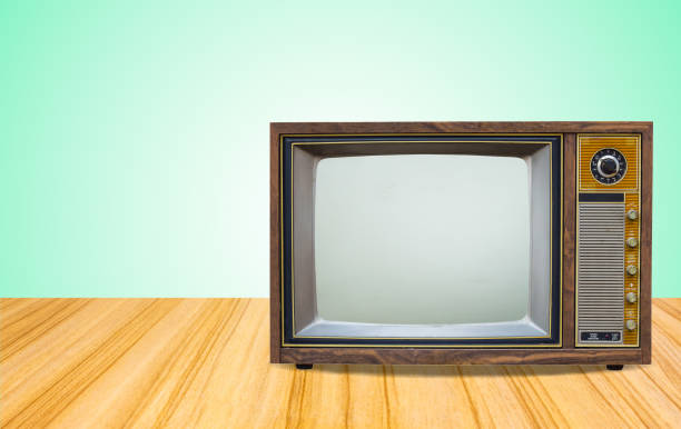 istock Retro old television receiver on table front gradient green wall background.vintage tv with cut screen on perspective wooden floor. 1146161021