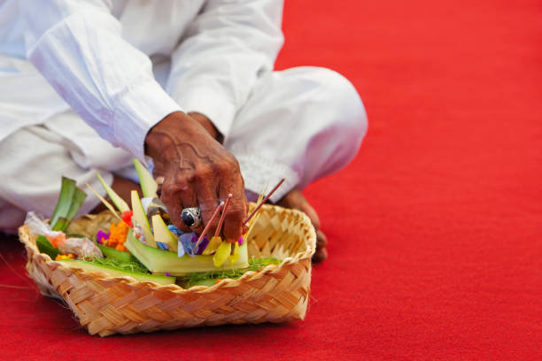 Beautiful Asian woman prays in the temple. Bali. Indonesia