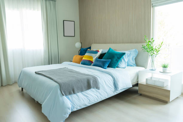 istock Clean modern bedroom with blue and yellow cushion setting on it. 1146168170