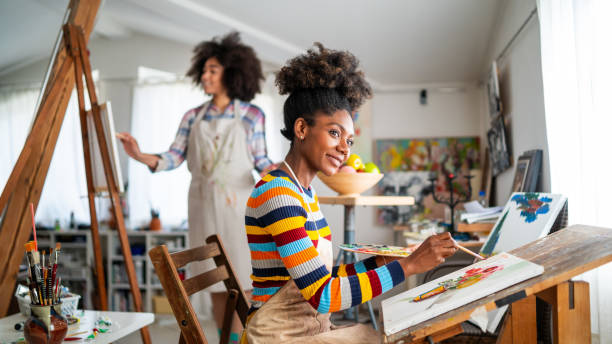 istock Afro Female fine artists drawing in studio 1146173042