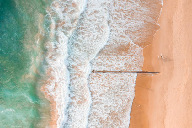 istock Aerial shot of beautiful beach with sand and wave patterns 1146173045