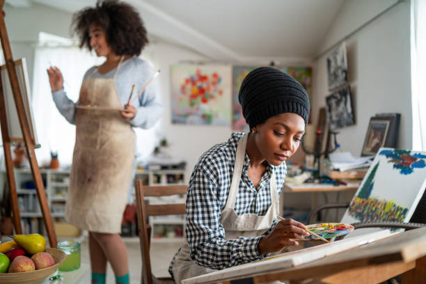 istock Afro Female fine artists drawing in studio 1146173046