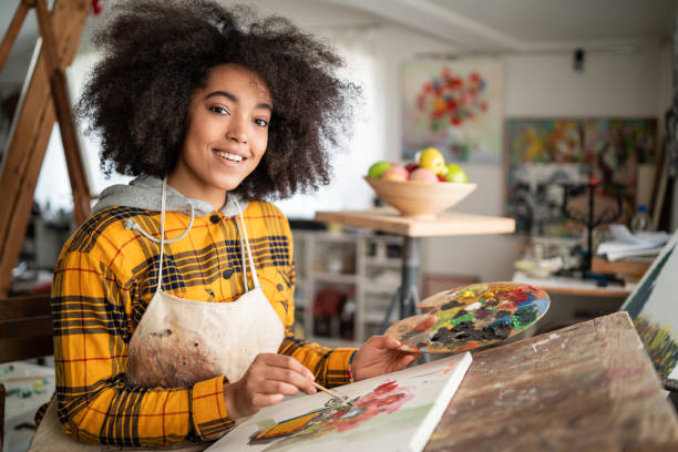 istock Young afro woman drawing 1146173048