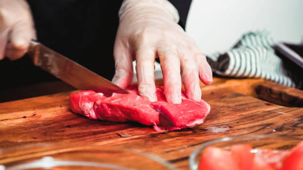 istock Slicing beef into the small cubes for beet soup, borscht. 1146174765
