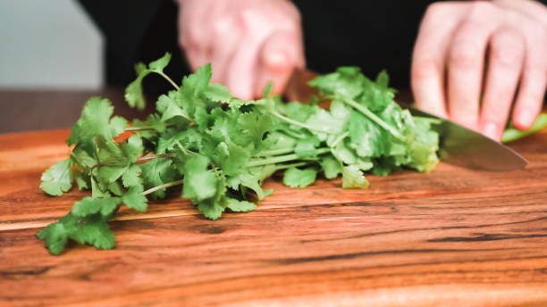 istock Slicing fresh parsley to garnish beet soup, borscht. 1146175313