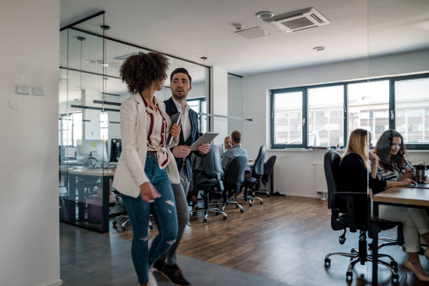 istock Business colleagues walking in the office 1146187201