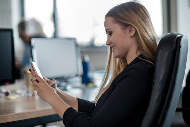 istock Businesswoman using phone in the office 1146187203