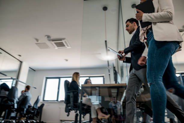 istock Business colleagues walking in the office 1146187227