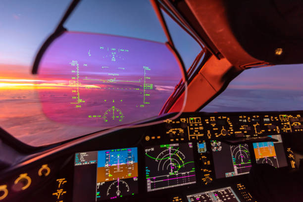 Sunrise view from modern aircraft cockpit with Heads up Display and flight instruments stock photo