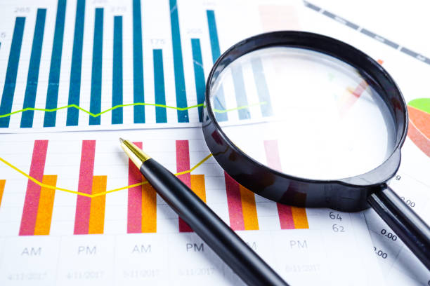 istock Magnifying glass on charts graphs spreadsheet paper. Financial development, Banking Account, Statistics, Investment Analytic research data economy, Stock exchange trading, Business office company meeting concept. 1146190725