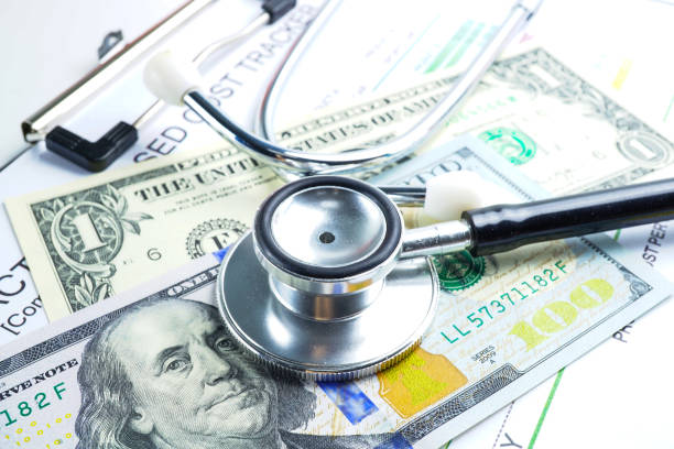 istock Stethoscope and US dollar banknotes on chart or graph paper, Financial, account, statistics and business data  medical health concept. 1146190734