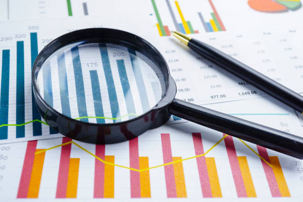 istock Magnifying glass on charts graphs spreadsheet paper. Financial development, Banking Account, Statistics, Investment Analytic research data economy, Stock exchange trading, Business office company meeting concept. 1146190741