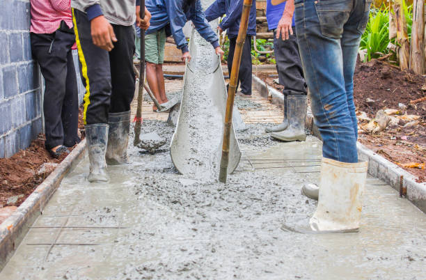 istock Concrete ready mix for building floor. worker leveling concrete poured from mixer on construction site in Thailand 1146193169