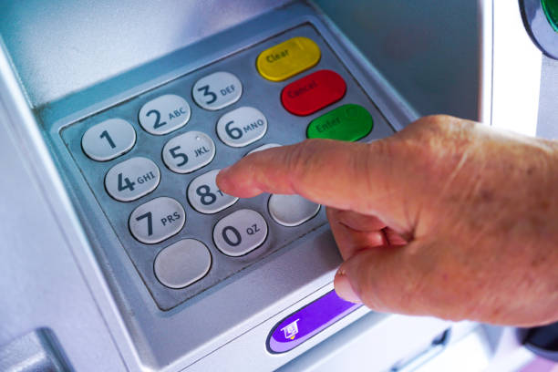 istock Asian senior or elderly old lady woman entering press button number code on machine to withdraw, check or transfer money finance, bank and people concept 1146193702