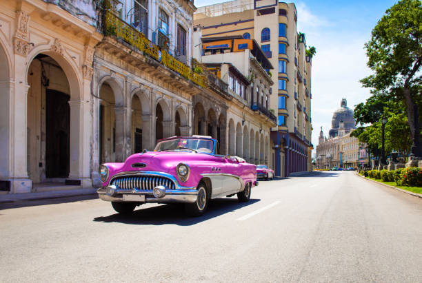 Cityscape with american pink 1954 convertible vintage car on the main street in Havana City Cuba - Serie Cuba Reportage stock photo