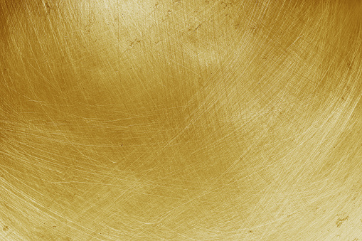 aluminium texture background with gold gradient, pattern of scratches on stainless steel.