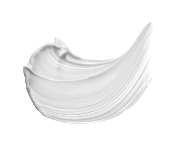Smear of face cream White smear of clay mask or face cream isolated on a white background cream colored stock pictures, royalty-free photos & images