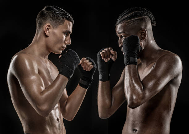 Two Multi-ethnic fight sport athletes facing off