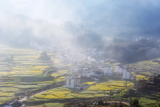 Photo of beautiful wuyuan mountain village in morning mist