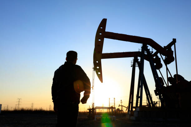 istock oil field, the oil workers are working 1146200564