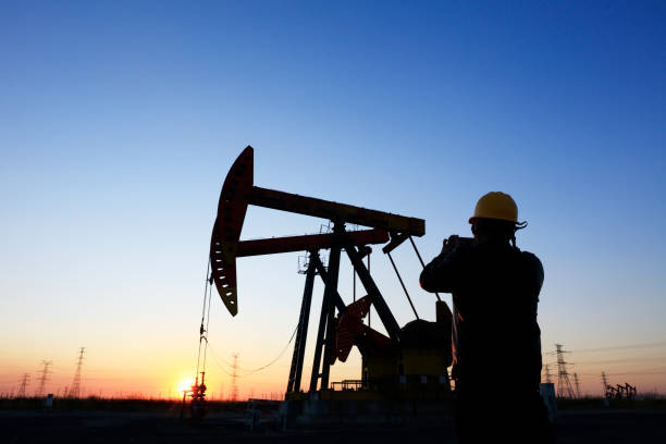 istock oil field, the oil workers are working 1146200972