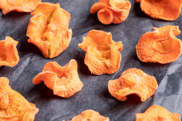 istock Close-up carrot chips  on black wrapping paper. 1146201306