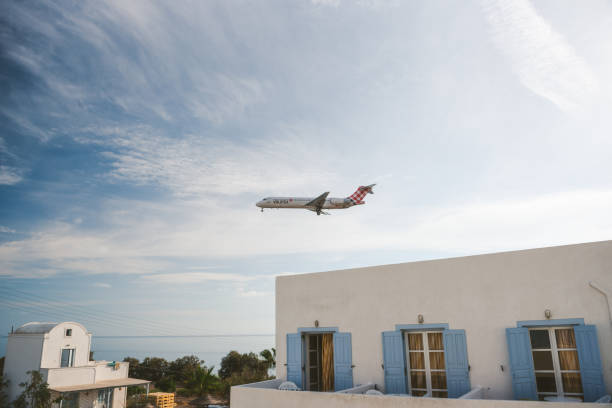 Santorini, Greece - October 3,, 2018, Commercial Aircraft of Volotea Overhead, heading to Santorini airport. Shot from Kamari town