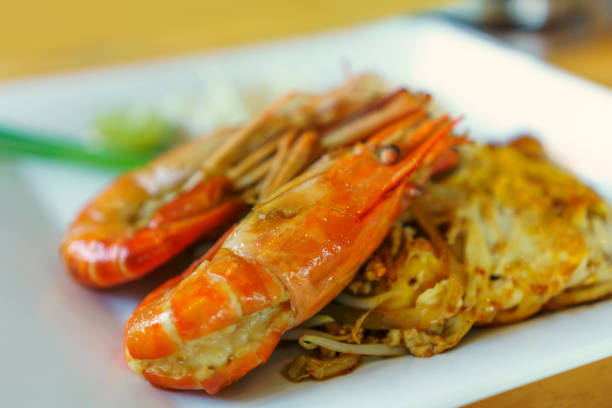 istock Close up single cooked shrimp on Pad Thai stir fried noodle pile 1146206989
