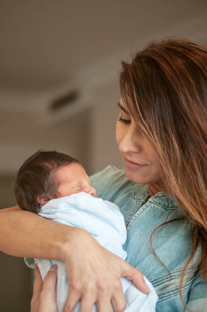 istock Young aunt holding her newborn nephew 1146210247